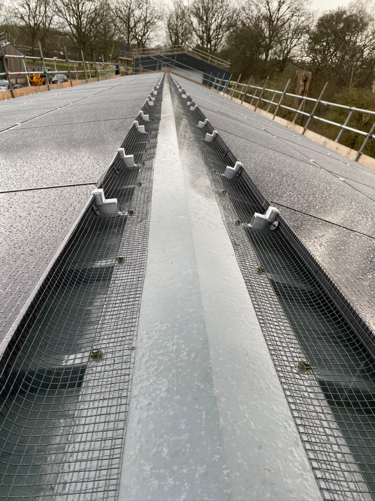 Solar panel installation on brick residential property with scaffolding